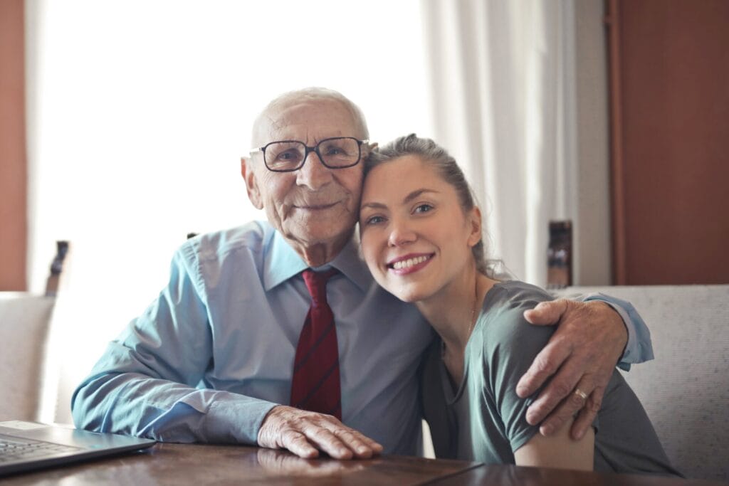 Picture of elderly man hugging a younger woman