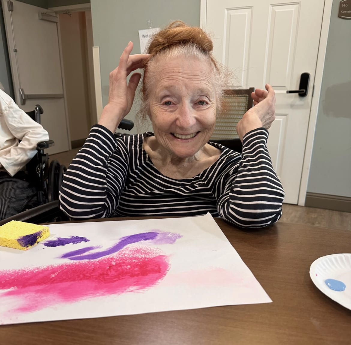 A senior smiling with a hand-drawn heart image below her