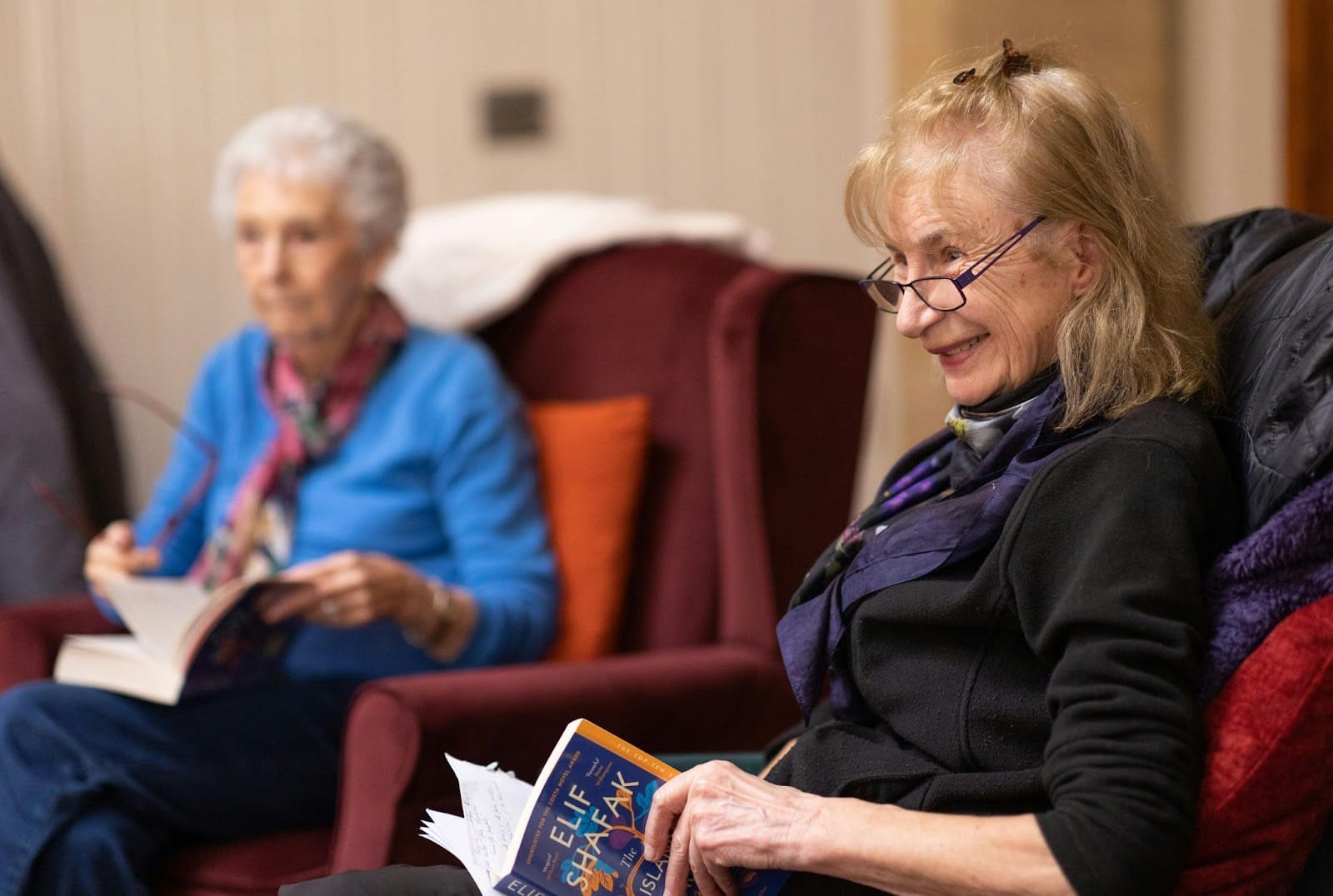 Elderly senior citizens reading a book in book club