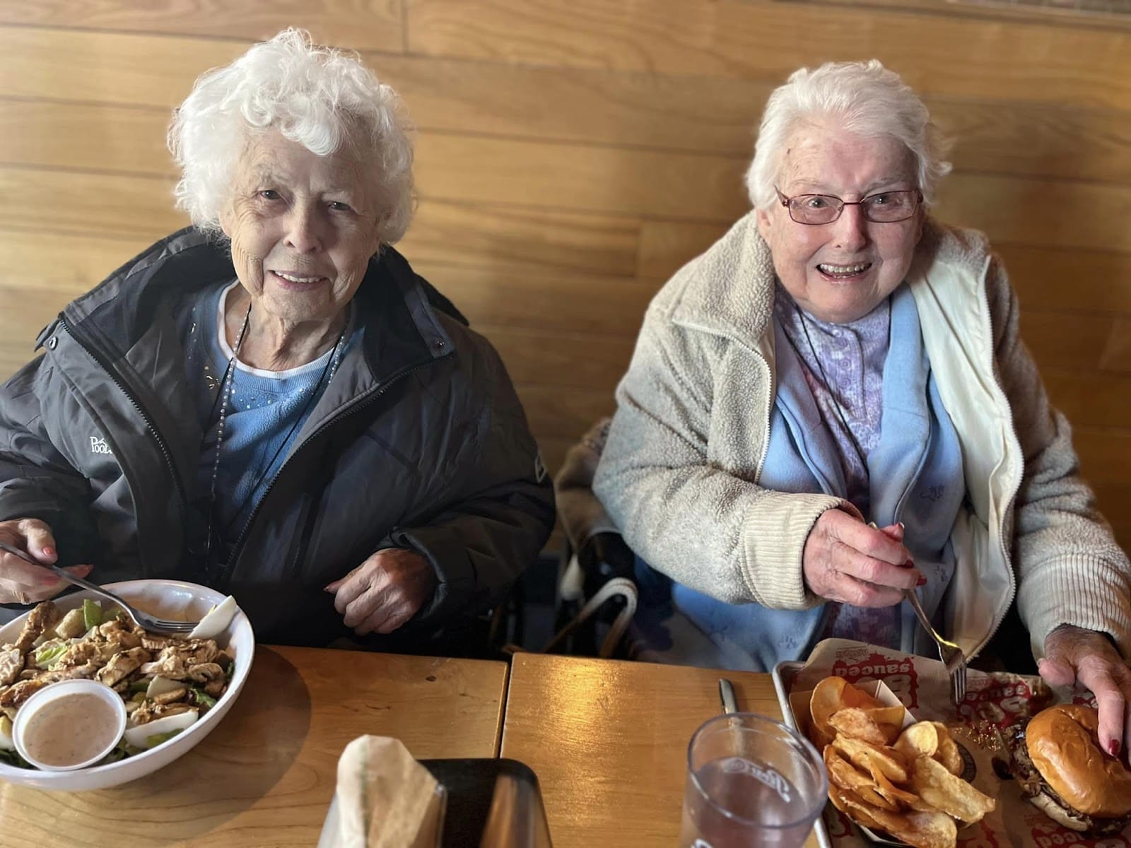 Two elderly women enjoying a delicious meal