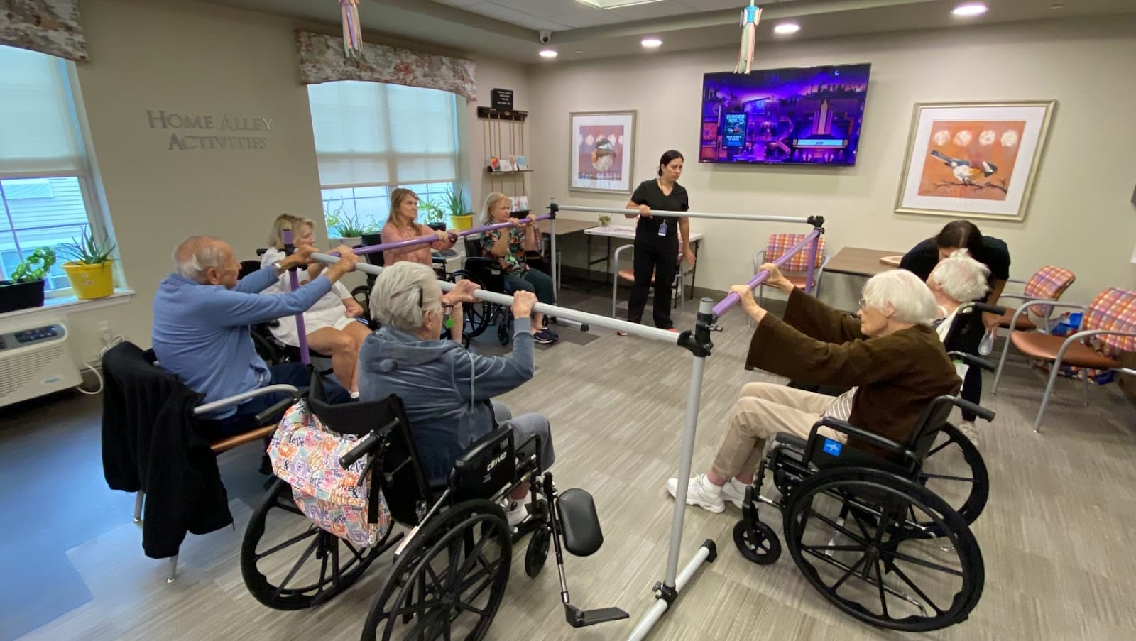 A group of seniors in wheelchairs in a memory care facility