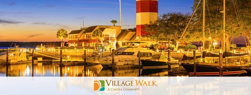 A banner displaying a local bay with the Village Walk logo at the bottom of the banner