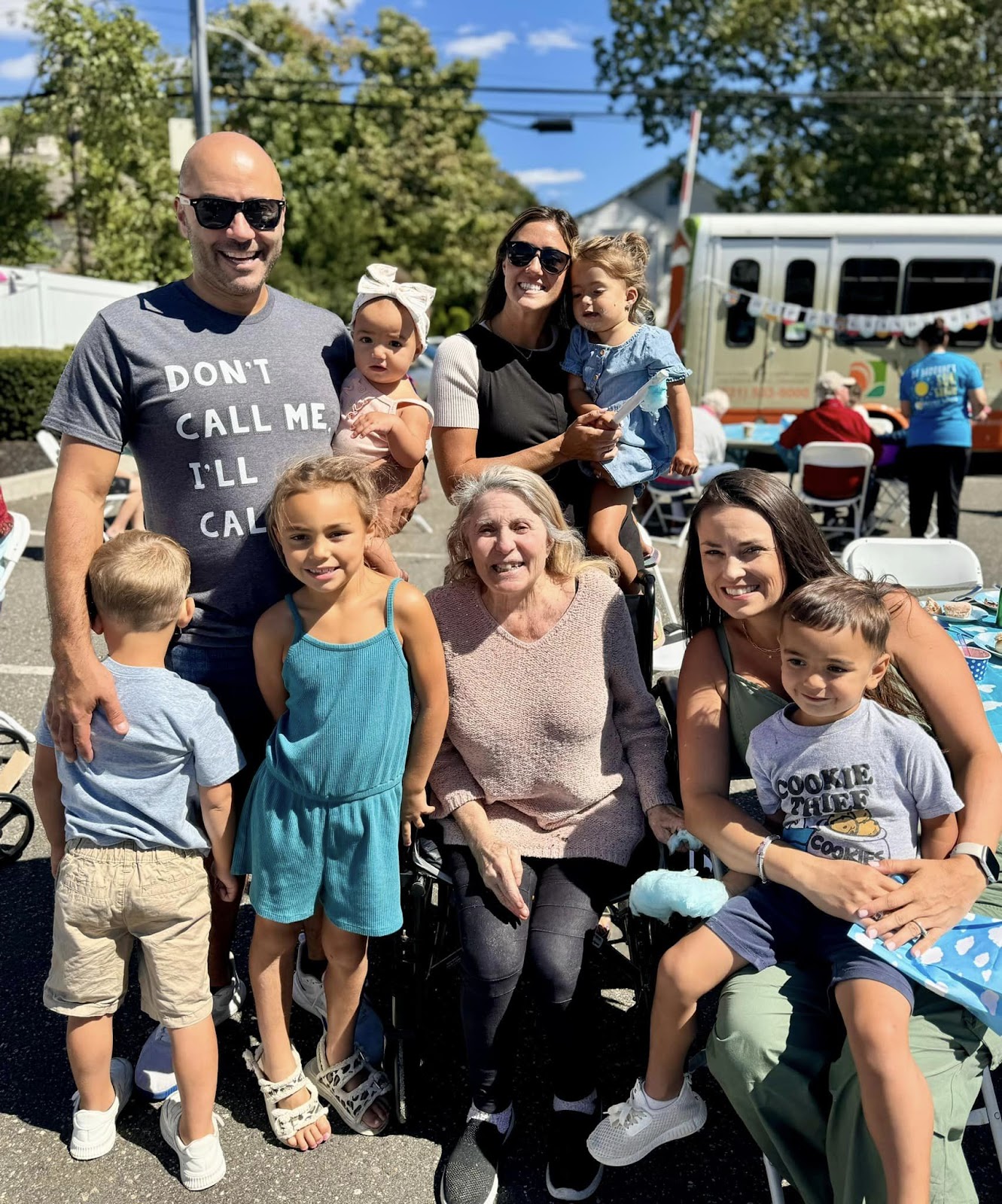 A family of children and parents around a woman with dementia