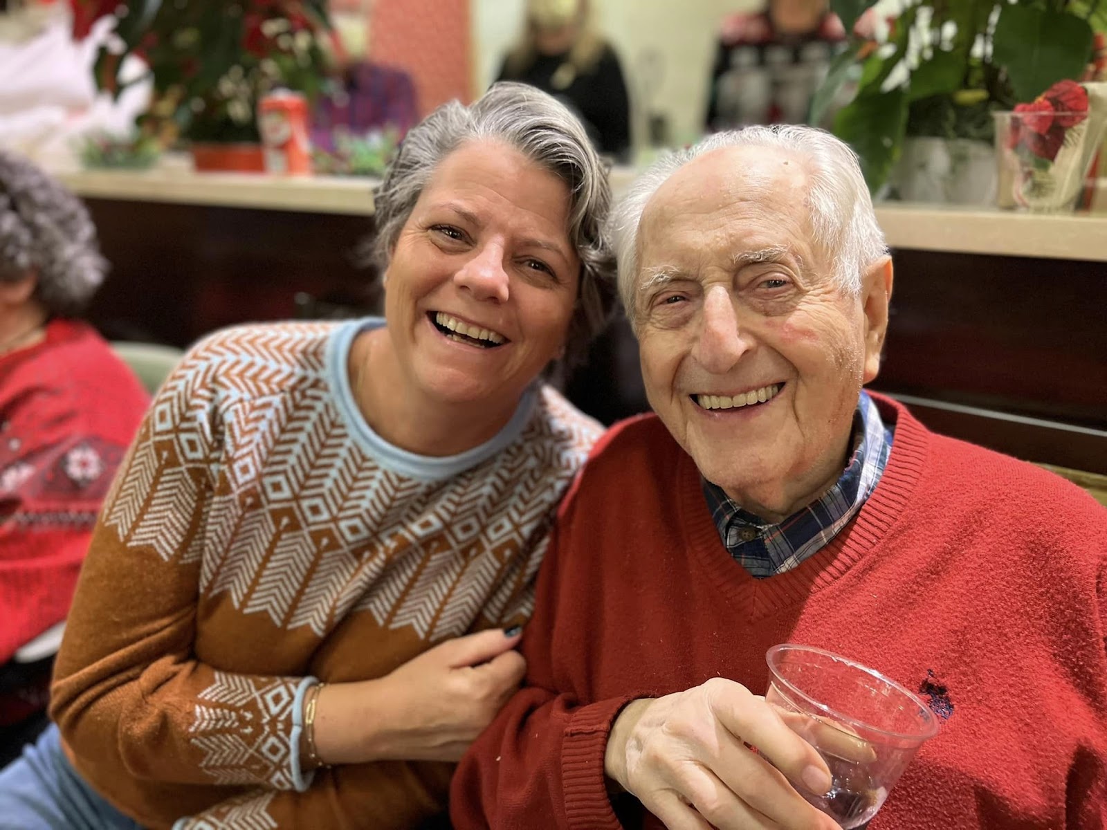 A couple smiling at the camera in an assisted living community