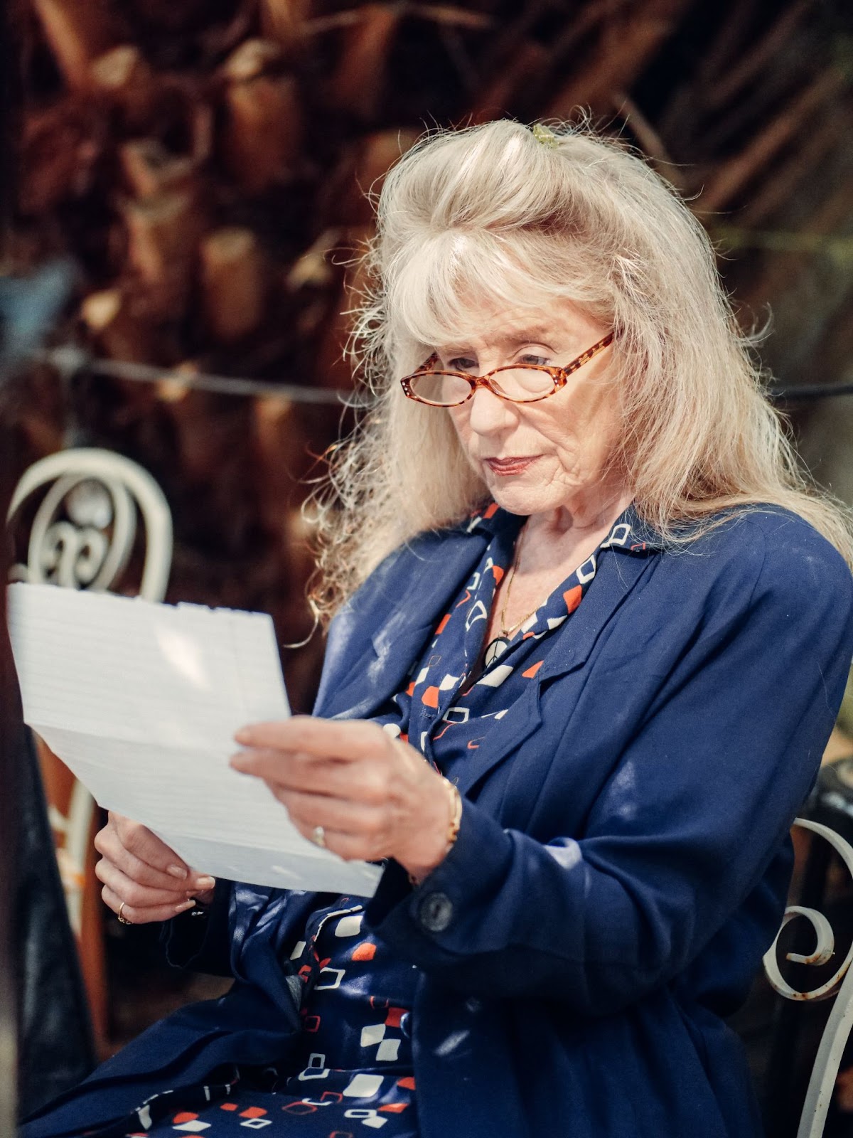 A senior citizen looking at a piece of paper, likely thinking about how much assisted living costs