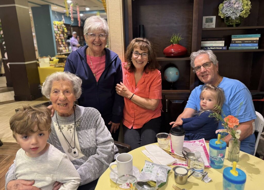 A smiling family at a memory care facility
