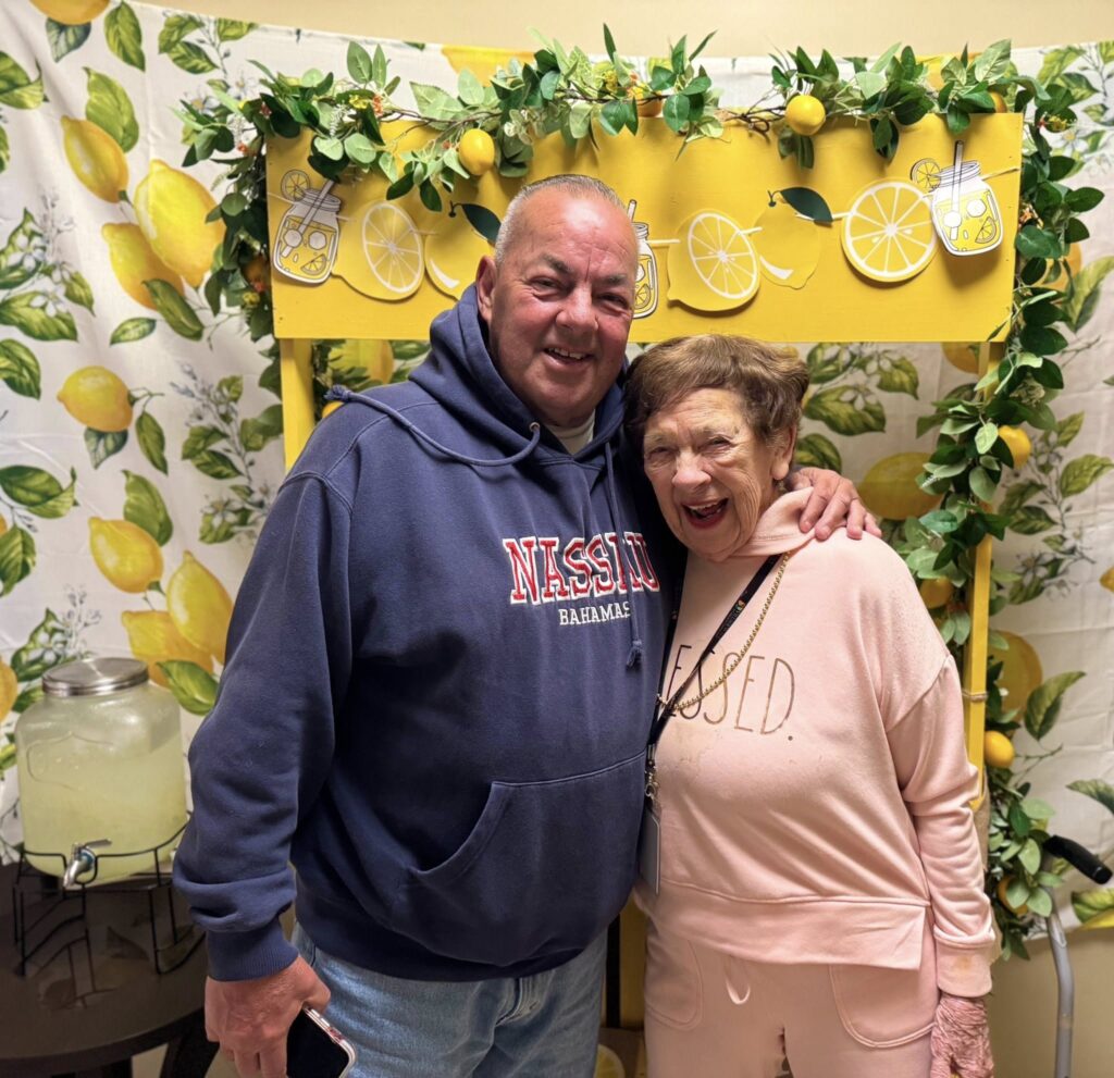 A woman and man smiling in a memory care community