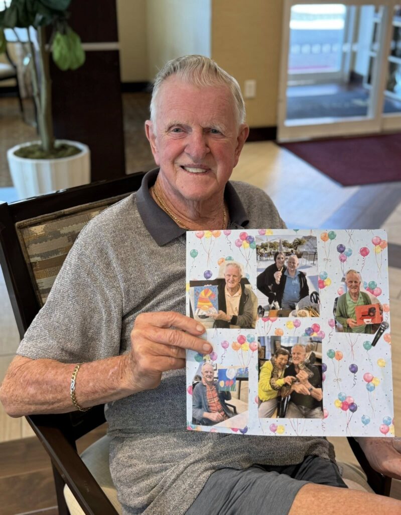 A resident in an assisted living facility holding up a collage