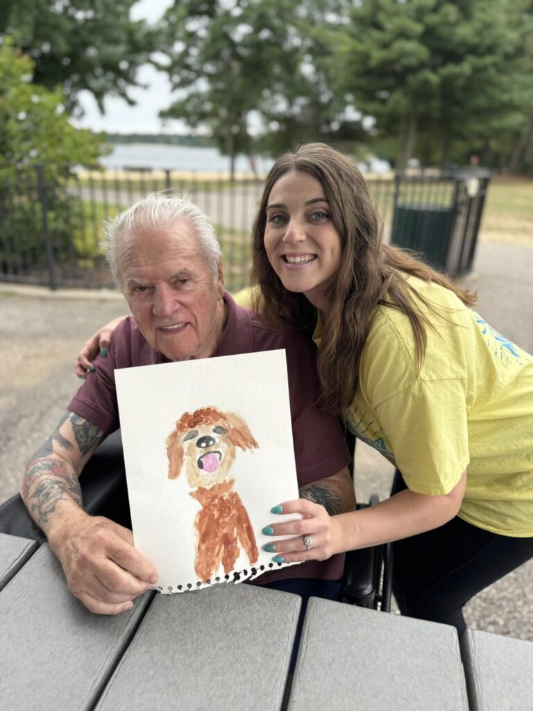 A picture of a man with a painted picture of a dog